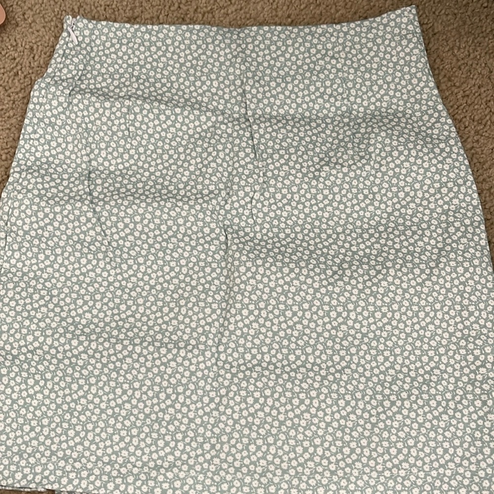 This super cute floral skirt in a size 6 but fits as a small and worn once.